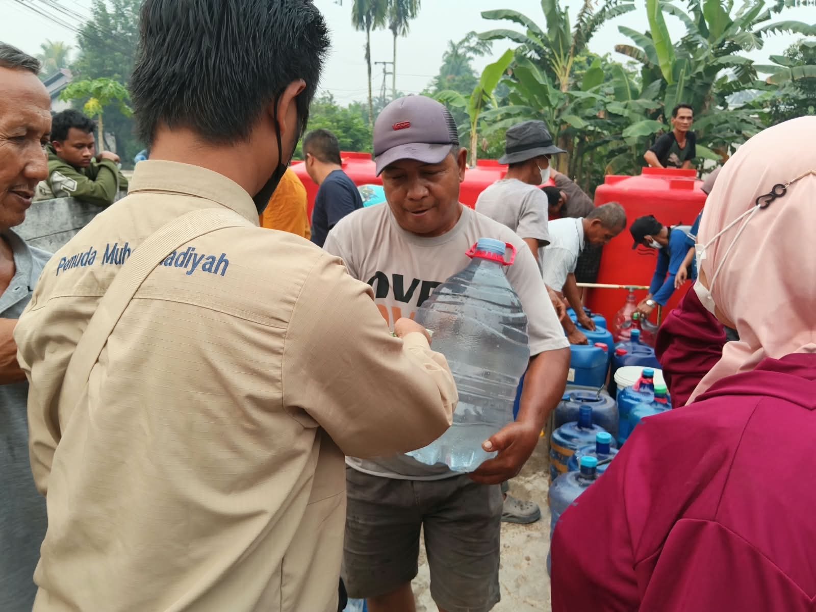 Pemuda Muhammadiyah saat bagikan air galon gratis untuk warga. Foto: Dok. Istimewa